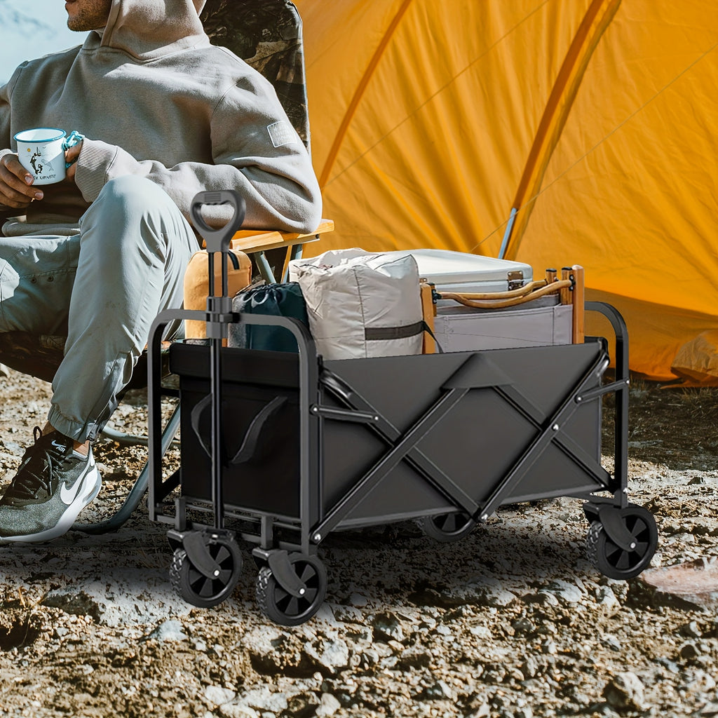 Person sitting with a camping scene featuring a black folding cart, cooler, and tent.