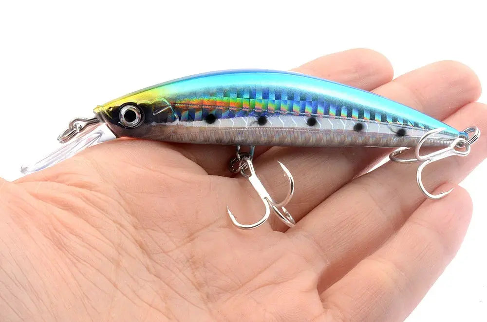 Colorful fishing lure held in a hand against a white background